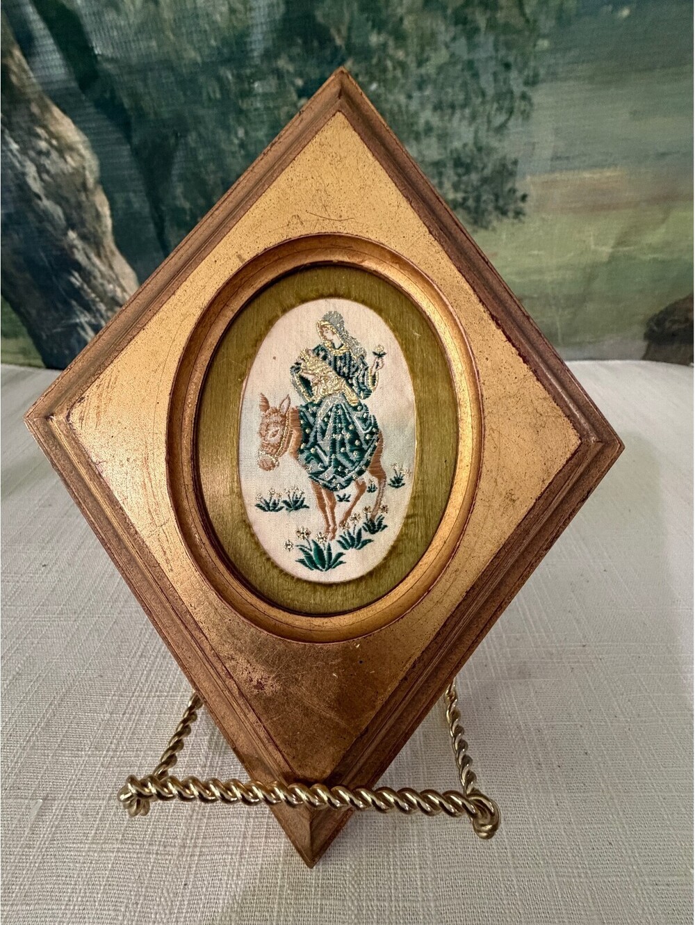 Diamond shaped wood frame with bird oval insert
